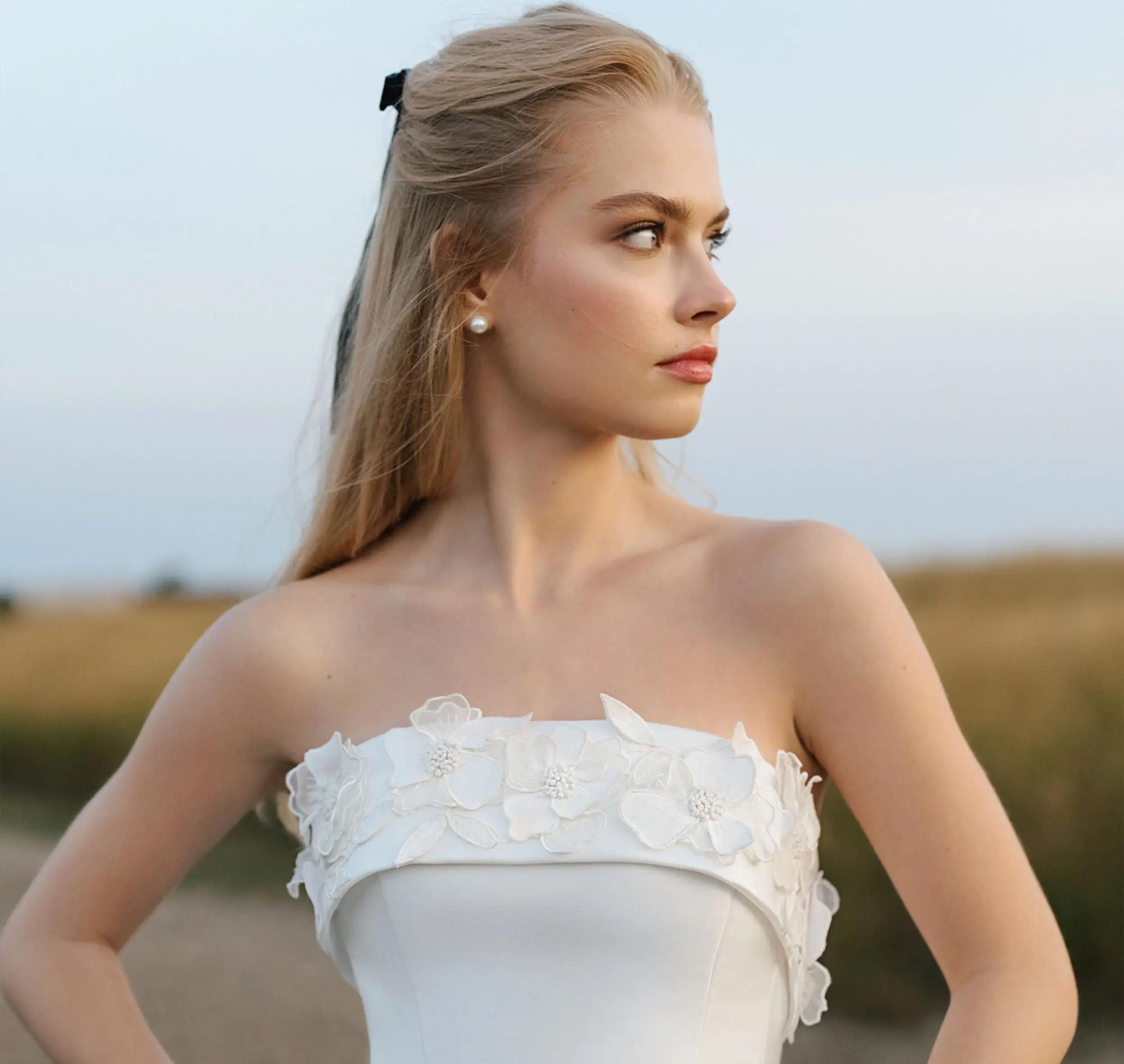 Model wearing a white laced bridal gown