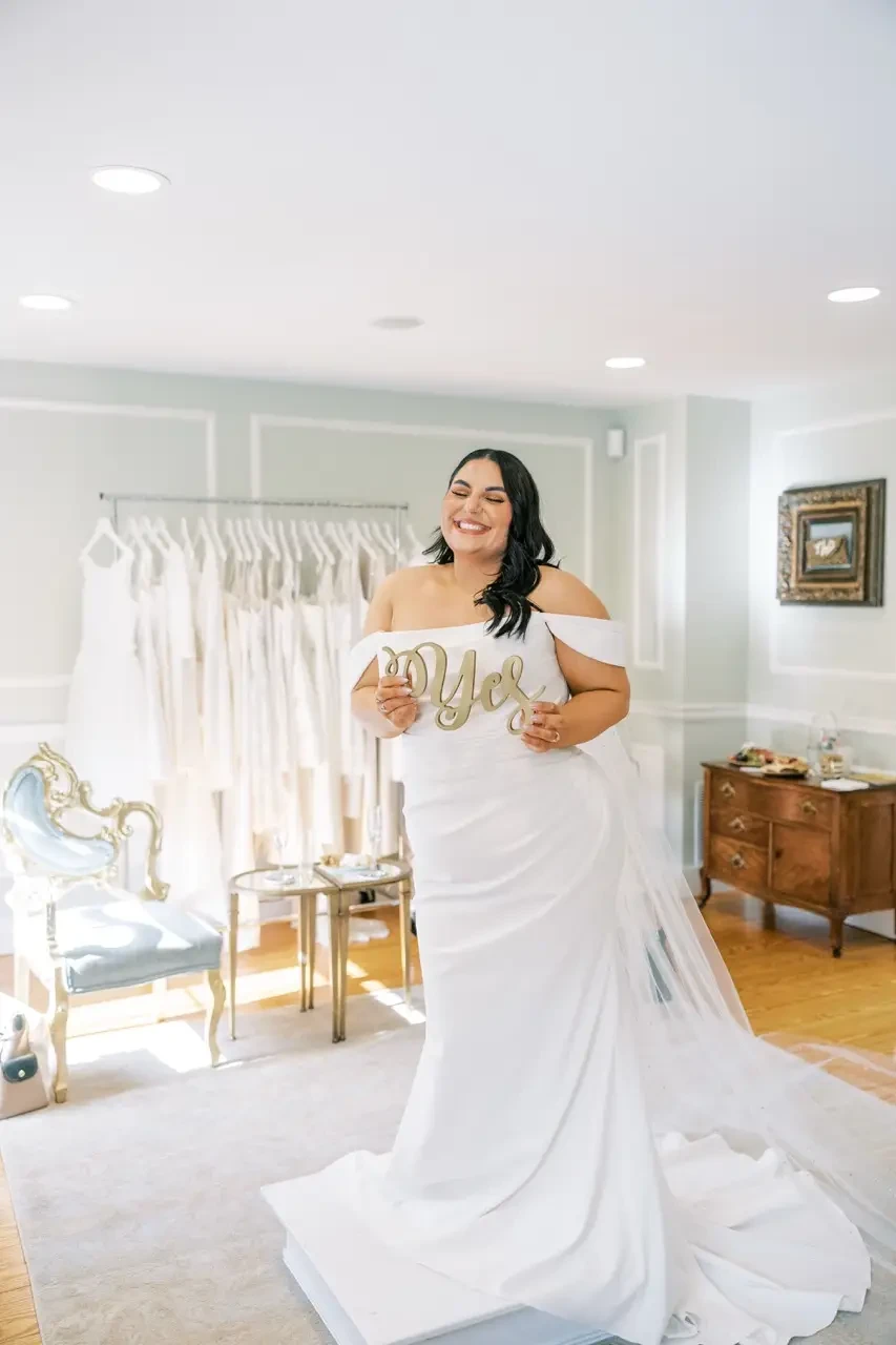 Bride saying yes to the dress in off-shoulder gown