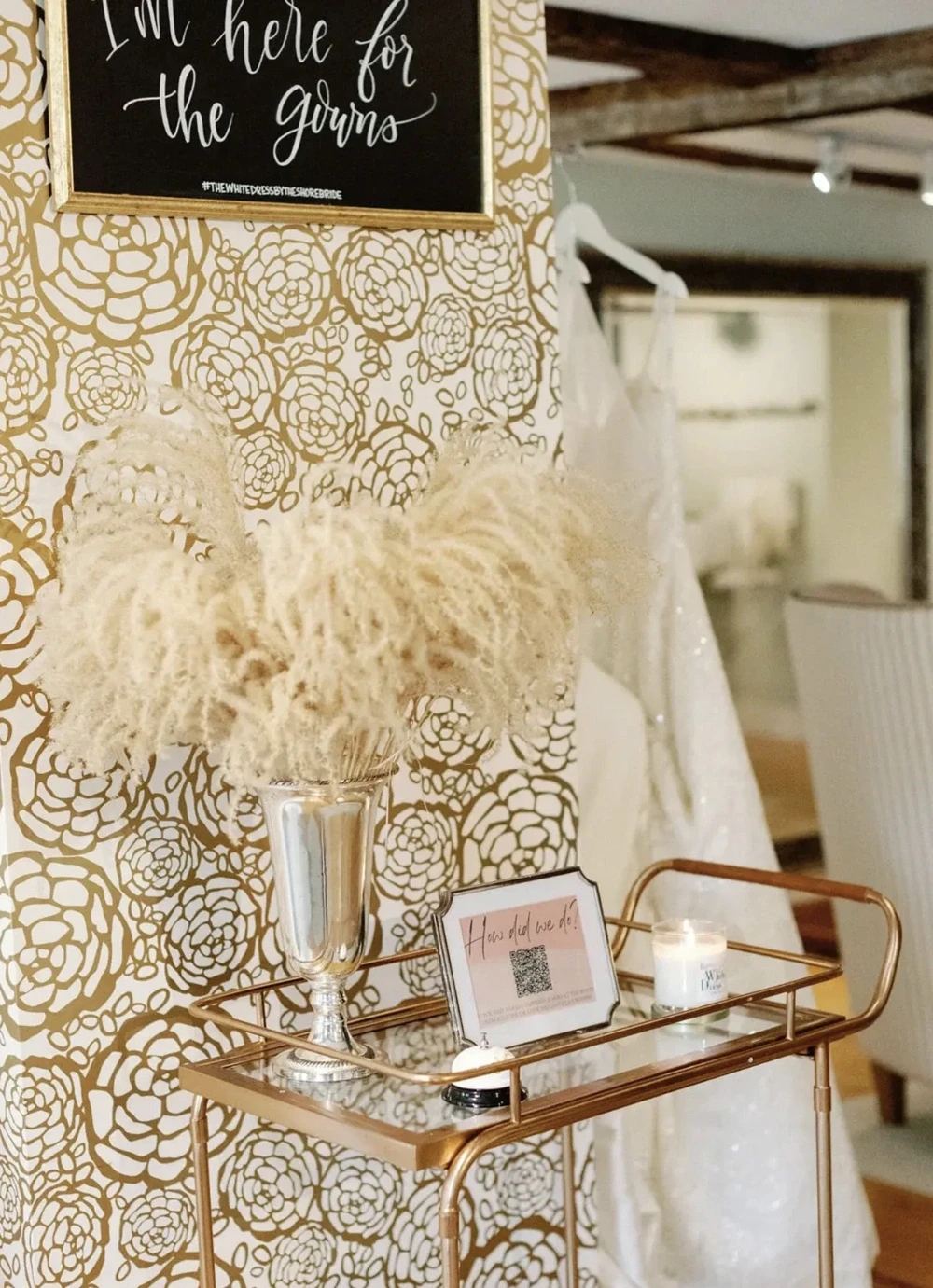 Bridal boutique decor with gold cart and pampas arrangement