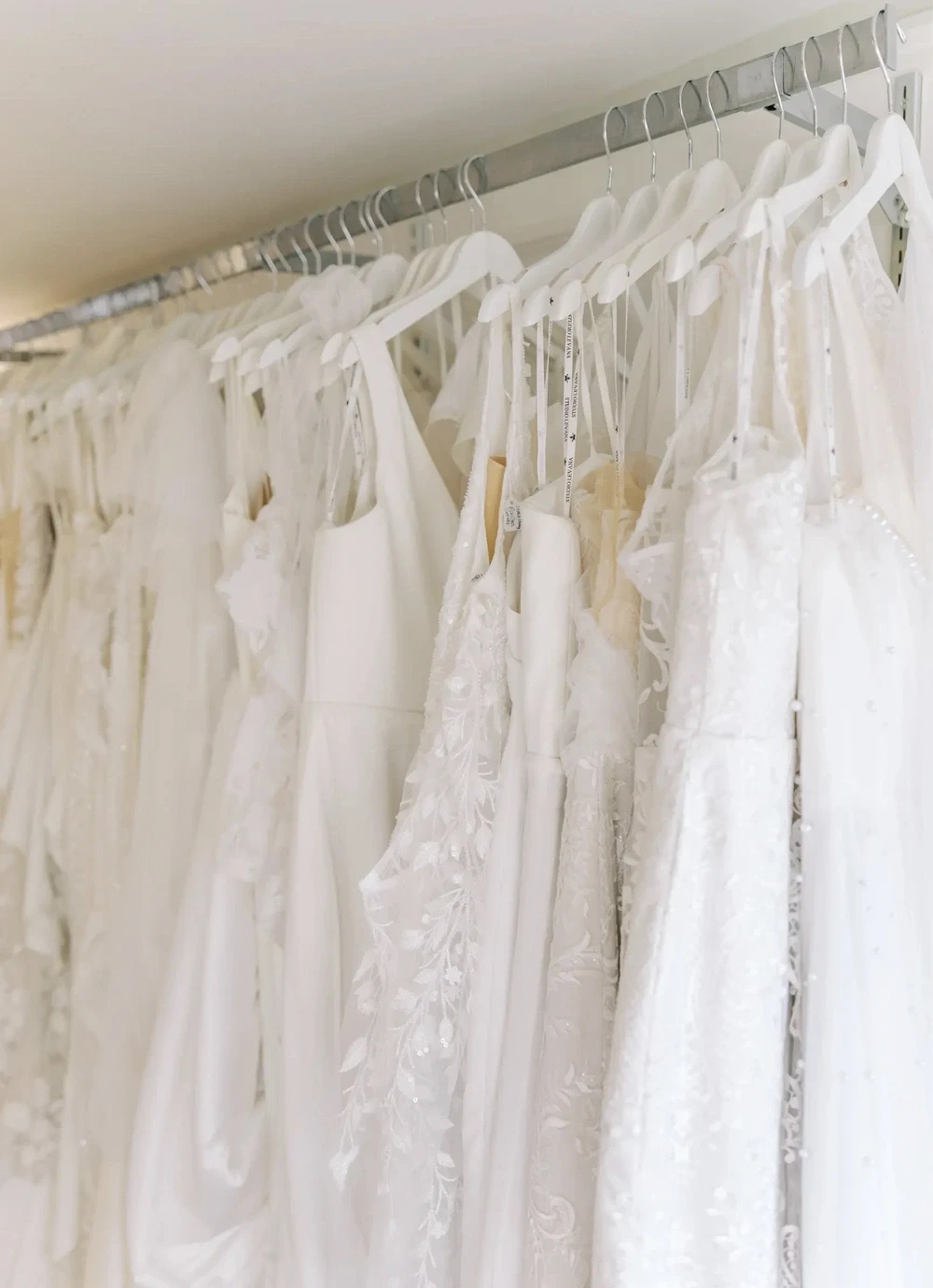 Elegant wedding dresses displayed in bridal shop
