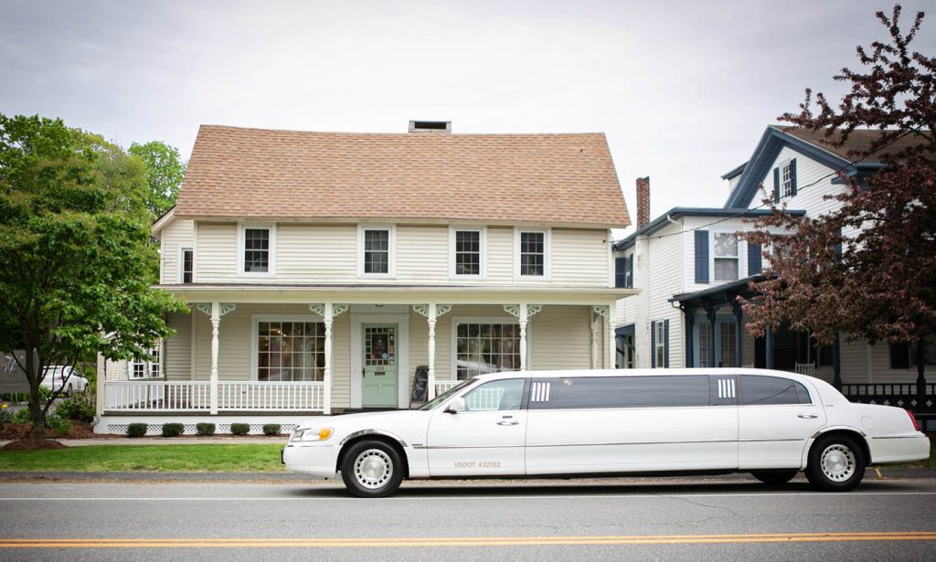 The White Dress by the shore and limo out front