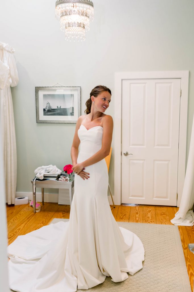 alex looking at herself in gown