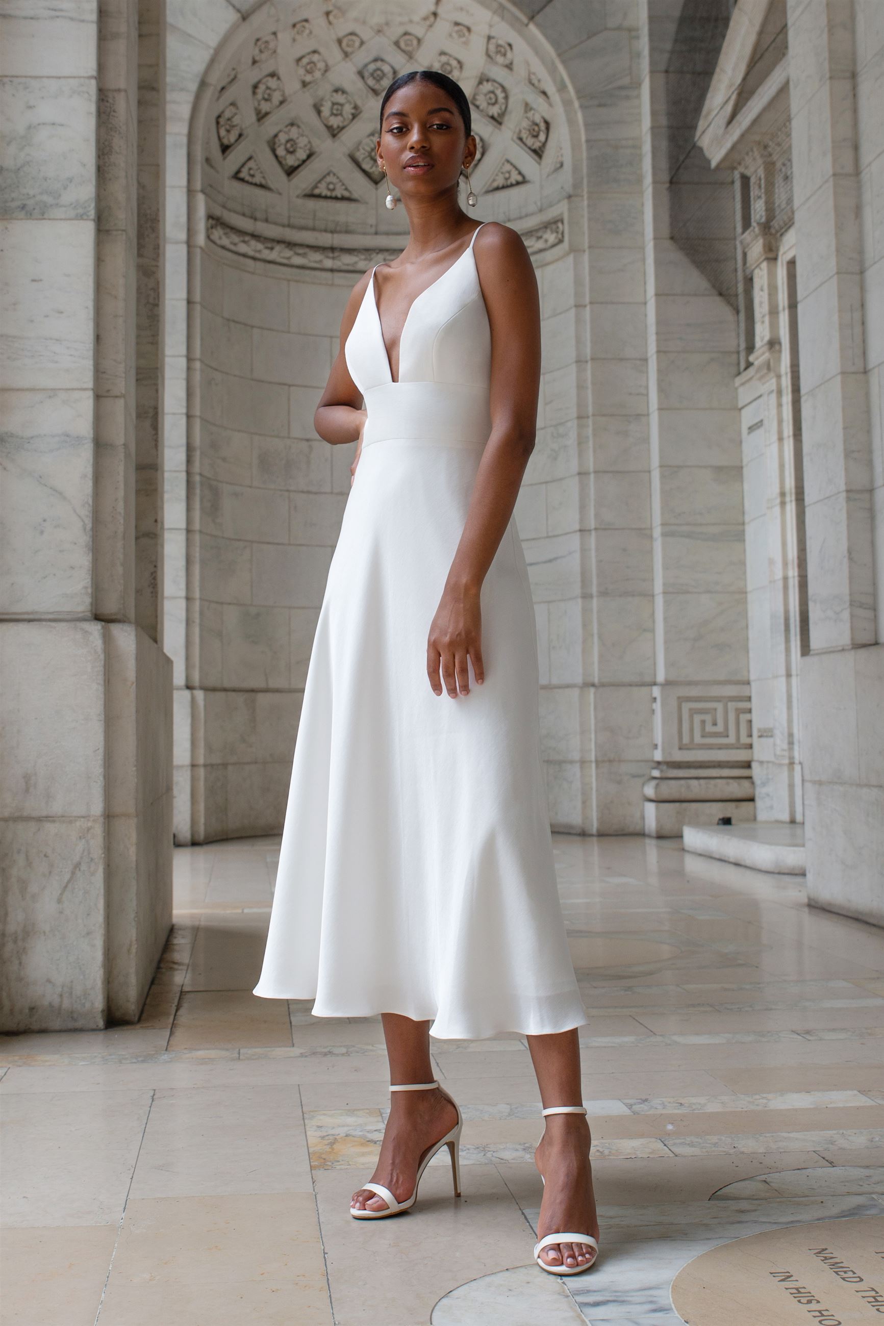 Bride wearing white midi dress with plunging neckline