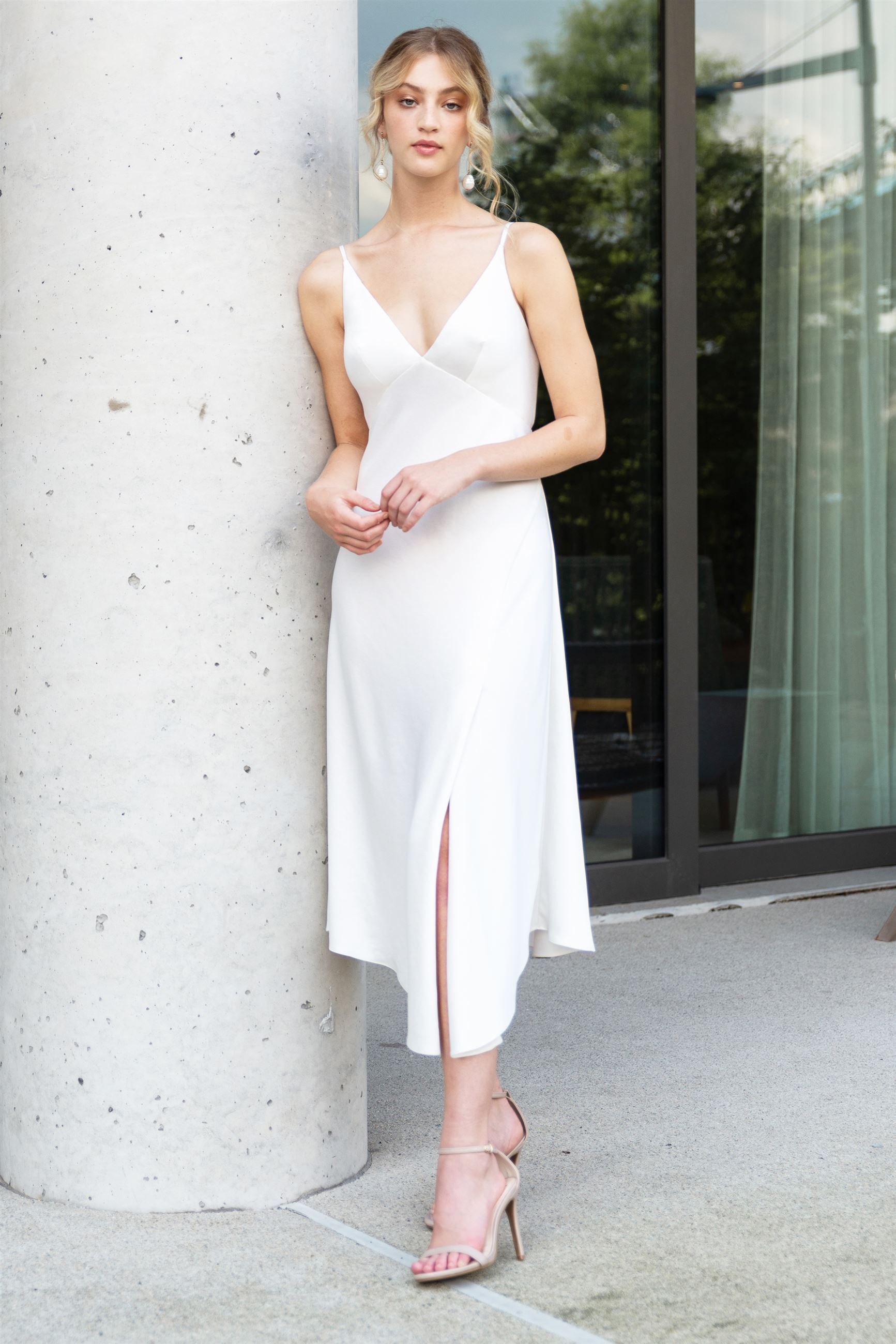 Bride wearing white slip dress with V-neckline