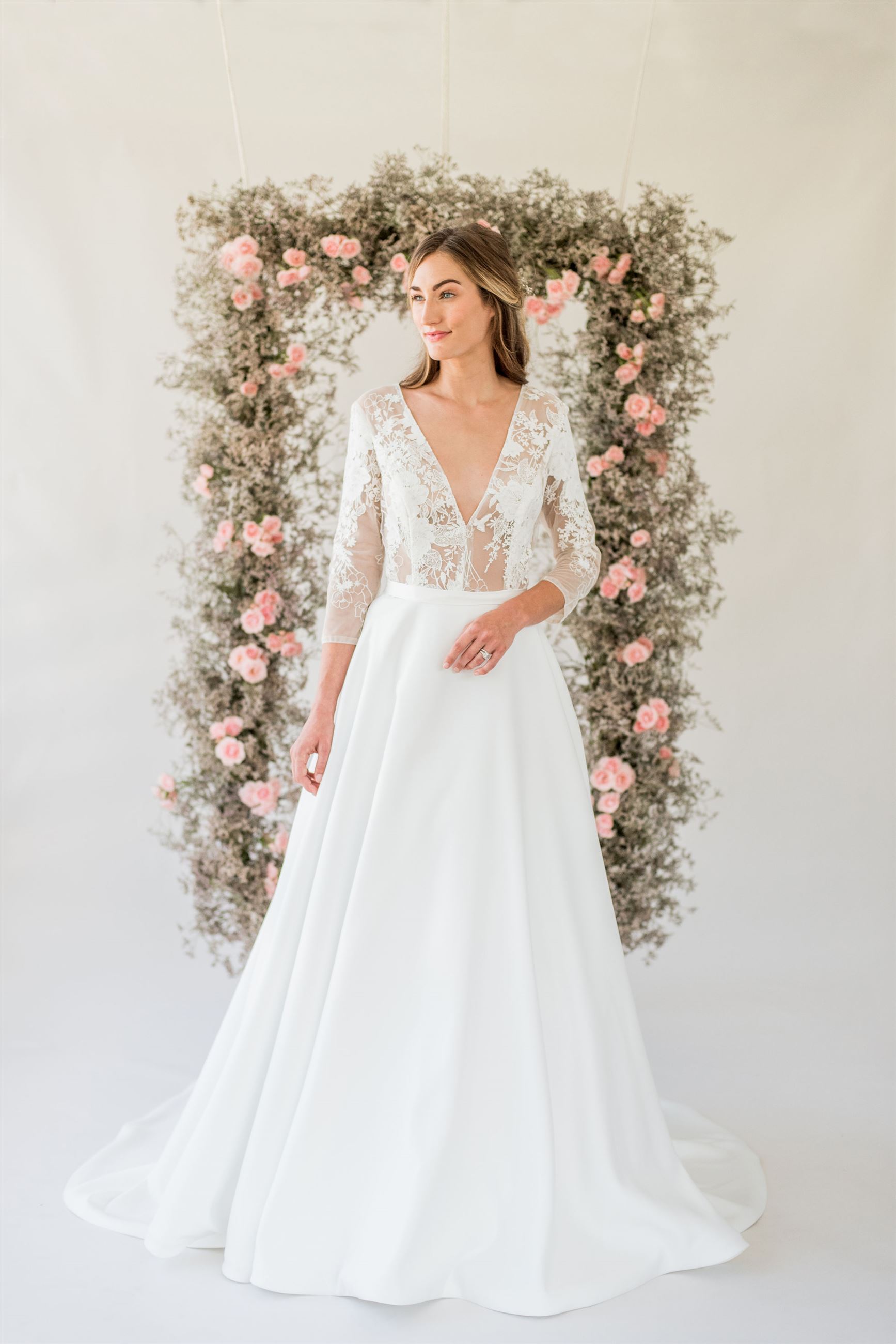 Bride wearing long sleeve wedding dress with sheer lace bodice
