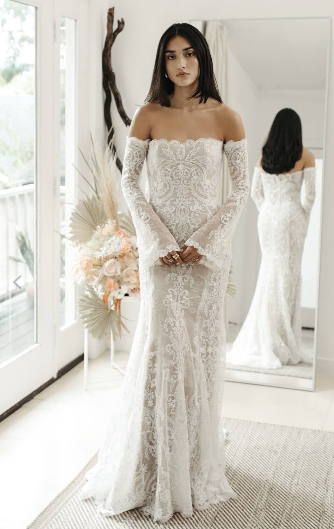 Bride wearing off the shoulder long sleeve wedding dress