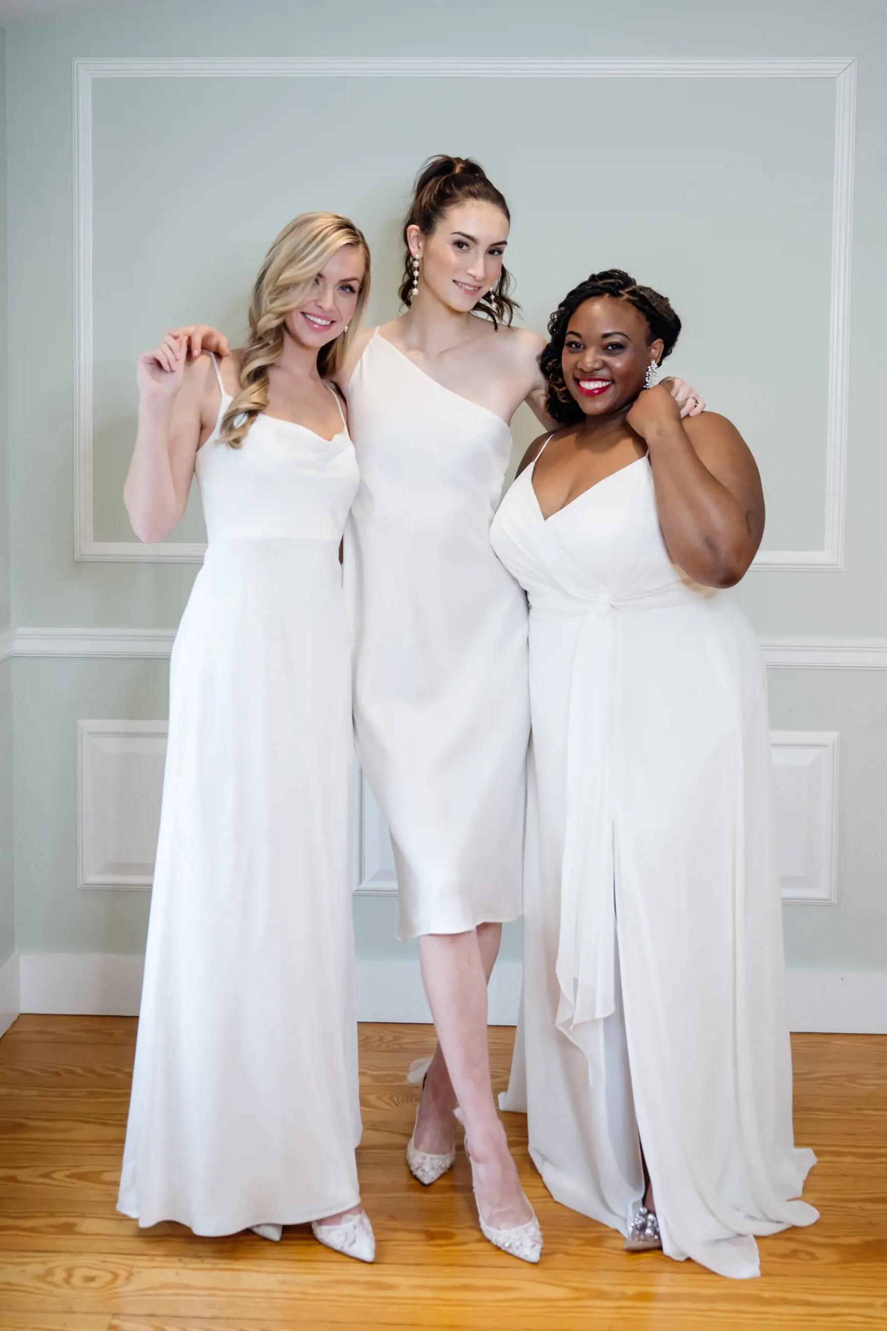 Three models wearing dresses from Little White Dress collection