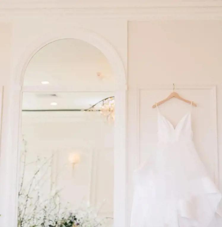 Image of wedding dress on a hanger in a bridal boutique
